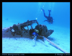 2 divers with a plane wreck in Jamaica. by Margo Cavis 